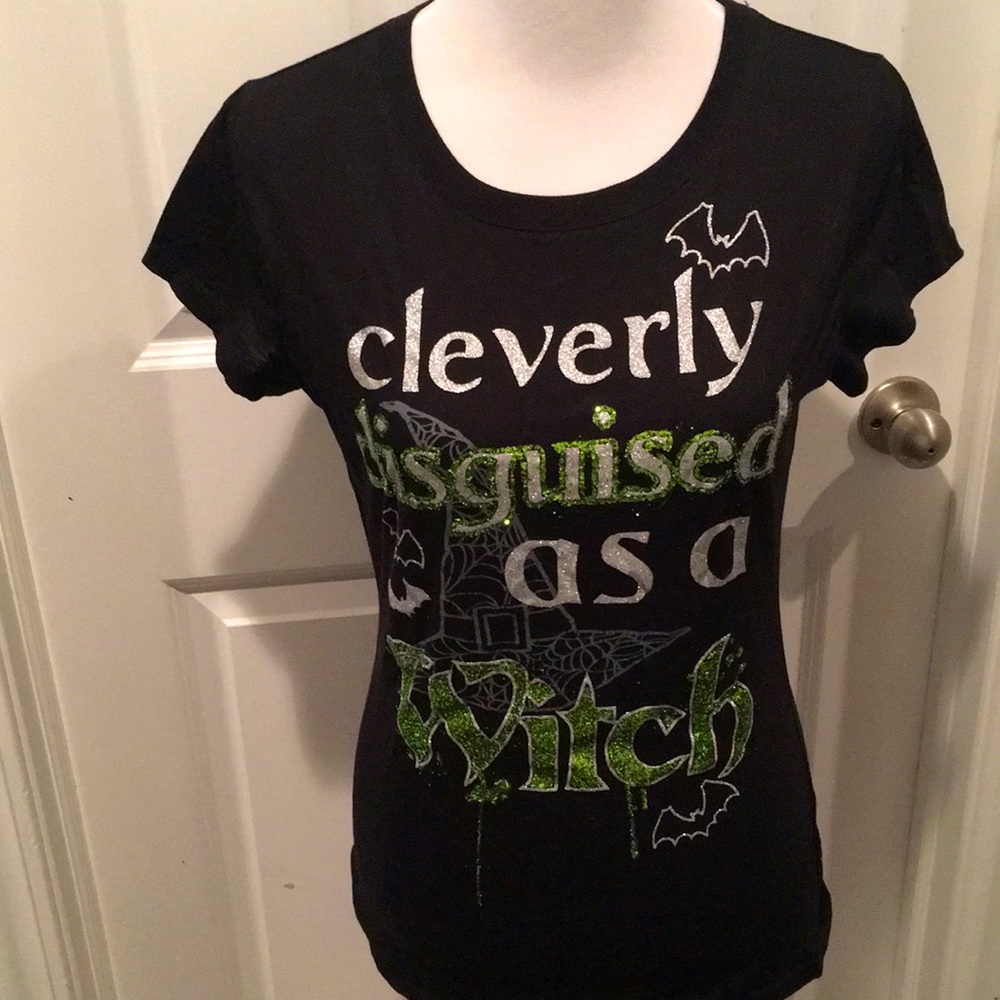 Black T-shirt with sequins saying “Cleverly disguised as a witch”